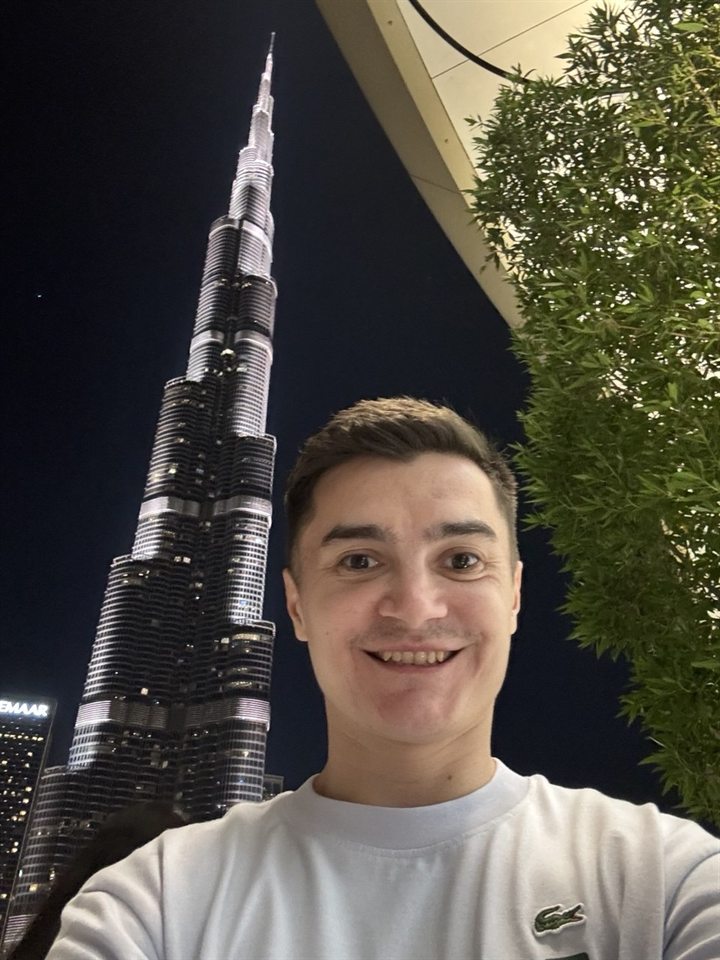 Sergei Korablev in front of the Burj Khalifa at night